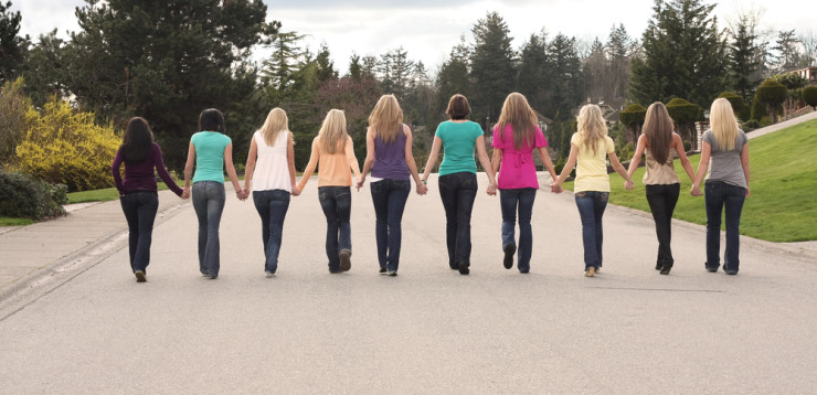 Ten beautiful girls, walking together hand in hand.