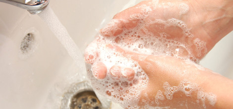 woman washing hand under running